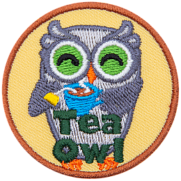 A grey owl smiles and holds a steaming cup of tea with the tea bag still in it. At the bottom of this crest are the words Tea Owl.