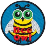 An owl wears a cute bee costume. The text Bee Owl is at the bottom of this round crest.