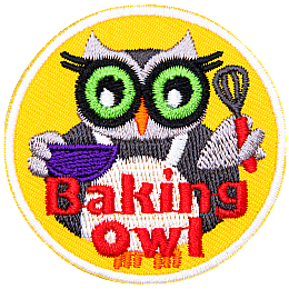 An owl stands in a white cooking apron and holds a bowl in its left wing and a whisk in its right. The words Baking Owl rest at the bottom center of the crest.