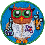 A brown owl dressed in a white lab coat and safety glasses holding two beakers of bubbling purple and orange liquids.