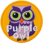 A purple owl with white accents. The words Purple Owl are at the bottom.