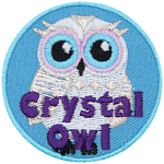 A white owl with the words Crystal Owl in purple thread at the bottom.