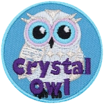 A white owl with the words Crystal Owl in purple thread at the bottom.