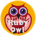 A red and pink owl with purple eyes. The words Ruby Owl are at the bottom.