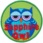 A fat blue owl with half-lidded eyes. The words Sapphire Owl are across the bottom.