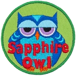 A fat blue owl with half-lidded eyes. The words Sapphire Owl are across the bottom.