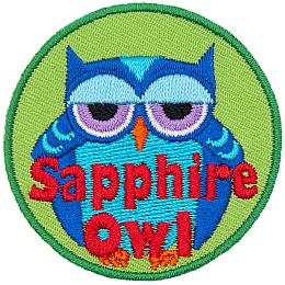 A fat blue owl with half-lidded eyes. The words Sapphire Owl are across the bottom.