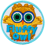 A fluffy brown owl with green eyes. The words Fluffy Owl are at the bottom.