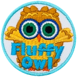 A fluffy brown owl with green eyes. The words Fluffy Owl are at the bottom.