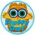A fluffy brown owl with green eyes. The words Fluffy Owl are at the bottom.