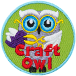 A white owl holding scissors and a paper heart. The words Craft Owl are at the bottom.