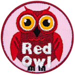 A red owl with yellow eyes. The words Red Owl are at the bottom.