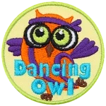 A purple and orange owl with a sweatband. The words Dancing Owl are across the bottom.