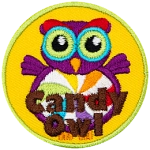 A purple owl with a swirled candy for its stomach. The words Candy Owl are at the bottom.