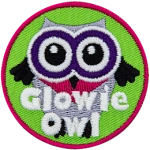 A white owl with black wings and purple eyes. The words Glowie Owl are across the bottom.