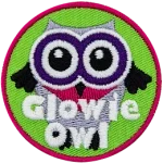 A white owl with black wings and purple eyes. The words Glowie Owl are across the bottom.