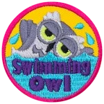 A white owl swimming in water. The words Swimming Owl are in the water.