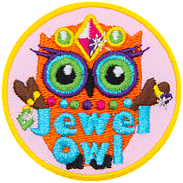 An orange owl wearing a crow, necklace and rings. The words Jewel Owl are across the bottom.