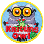 A grey owl with round glasses holding a pair of knitting needles and green yarn. The words Knitting Owl are across the bottom.