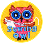 A pink owl with a sewing needle and fabric in hand. The words Sewing Owl are across the bottom.