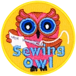 A pink owl with a sewing needle and fabric in hand. The words Sewing Owl are across the bottom.