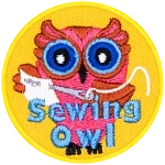 A pink owl with a sewing needle and fabric in hand. The words Sewing Owl are across the bottom.