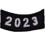 This black rocker curves upwards like a smile. The year number 2023 is embroidered in a bold font.