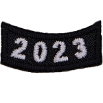 This black rocker curves upwards like a smile. The year number 2023 is embroidered in a bold font.