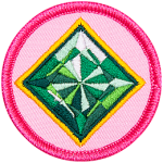 The top of an emerald is surrounded by a yellow ring on a pink background.