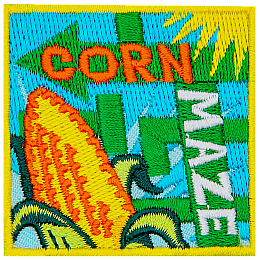 The words Corn Maze are on two arrows. An ear of corn is in the foreground.