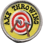 A yellow patch with a target on it that has two axes stuck into it. The words Axe Throwing.