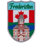 Fredericton’s City Hall is shown in front of the Canadian Flag.
