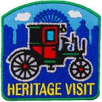 A red and green carriage above the words Heritage Visit.