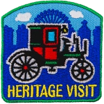A red and green carriage above the words Heritage Visit.