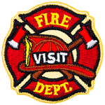 A fireman's hat sits on top of crossed axes, which itself is in front of the fire crest. The words Fire Visit Dept are down the middle.