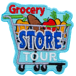 A shopping cart is loaded with food: a pepper, loaf of bread, apple, and carrots. The word Grocery sits above the cart, Store is written on the cart, and Tour rests under the cart but above the wheels.