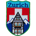 The name Zurich is above the swiss alps and the swiss flag. A chalet sits in the foreground. 