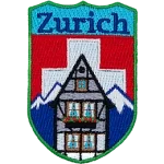 The name Zurich is above the swiss alps and the swiss flag. A chalet sits in the foreground. 