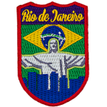 The words Rio de Janeiro are above Christ the Redeemer, which overlooks a blue silhouette of the city. The flag of Brazil is in the background.