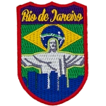 The words Rio de Janeiro are above Christ the Redeemer, which overlooks a blue silhouette of the city. The flag of Brazil is in the background.