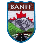 The name Banff is above a mountain landscape and road. The Canadian flag replaces the sky.