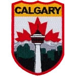 The name Calgary is at the top of the patch. The Calgary Tower is in the center in front of the mountains. The Canadian flag replaces the sky.
