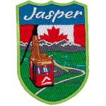 Jasper is stitched above the Jasper Sky-Tram overlooking a mountain valley. The sky is replaced by the flag of Canada.