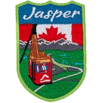 Jasper is stitched above the Jasper Sky-Tram overlooking a mountain valley. The sky is replaced by the flag of Canada.