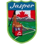 Jasper is stitched above the Jasper Sky-Tram overlooking a mountain valley. The sky is replaced by the flag of Canada.
