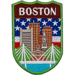 The skyline of Boston is in front of the flag of America. The name Boston is at the top.