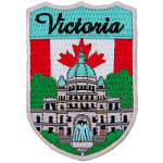 The word Victoria is above the parliament building in Vancouver. The flag of Canada is in the background.