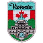 The word Victoria is above the parliament building in Vancouver. The flag of Canada is in the background.