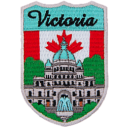 The word Victoria is above the parliament building in Vancouver. The flag of Canada is in the background.