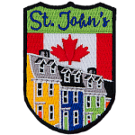 This shield-shaped crest has the text St. John's at the top. The iconic Jellybean Row of the city is displayed with the Canada flag in the background.